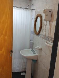 ein Bad mit einem Waschbecken und einem Spiegel in der Unterkunft Cabañas El Labriego in Malargüe