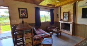 a living room with a couch and a fireplace at Pousada Trinca Ferro in Bom Retiro