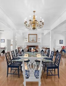 a dining room with a table and chairs and a chandelier at Rams Head Inn in Shelter Island