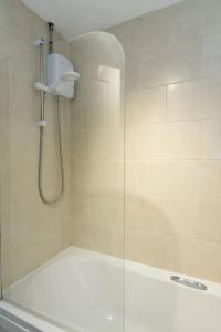 a shower with a glass door in a bathroom at Stylish two bedroom home SHEFFIELD in Sheffield