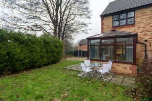 a patio with a table and chairs in front of a house at Stylish two bedroom home SHEFFIELD in Sheffield