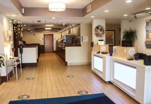 a lobby of a hospital with a waiting room at Holiday Inn Express Cedar Rapids - Collins Road, an IHG Hotel in Cedar Rapids