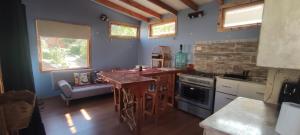 una cucina con tavolo e piano cottura forno superiore di Cabaña Hojitas de Laurel con Vista Panorámica a Pisco Elqui