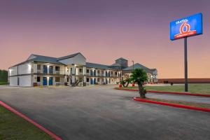 a building with a sign in a parking lot at Studio 6 - Texas City, TX in Texas City