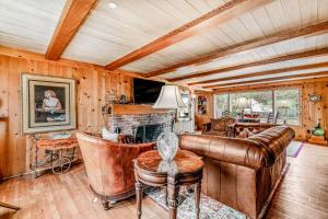 a living room with leather furniture and a fireplace at Slice of Life in Seaside