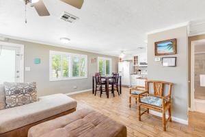 a living room with a couch and chairs and a kitchen at KCB Bungalow in Key Colony Beach