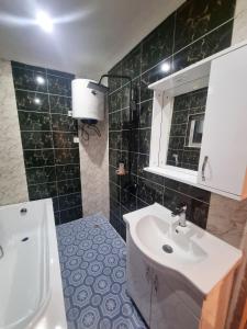 a bathroom with a sink and a toilet at Résidence Sighaka - Suite Royale - WiFi, Gardien, Parking in Douala