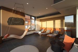 a waiting room with chairs and a hanging chair at Hotel Krone ****S in Tübingen