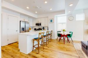 a kitchen and dining room with a table and chairs at Village Green Getaway in Park City