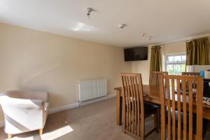 a dining room with a table and chairs at Bikehaus@The Colliers Arms in Abercanaid