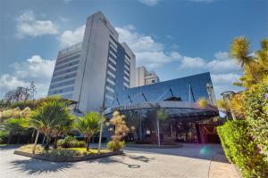 a building with palm trees in front of it at Wyndham Garden São Paulo Convention Nortel in São Paulo