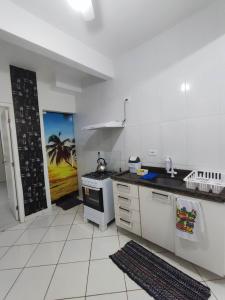 a kitchen with a sink and a stove at APARTAMENTO COQUEIROS A 1 QUADRA DO MAR in Guaratuba +15 photos