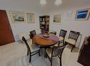 comedor con mesa de madera y sillas en Apartamento 2 dormitorios en Arcobaleno, en Punta del Este