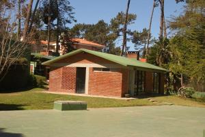 una casa de ladrillo rojo con techo verde en Apartamento 2 dormitorios en Arcobaleno, en Punta del Este