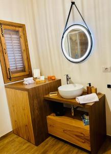 a bathroom with a sink and a mirror at Chalet in campagna in Partanna