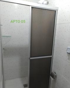 a shower stall with a door in a bathroom at Apartamento itapoá 30 in Itapoa