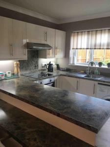 a kitchen with a large marble counter top at 1 bedroom apartment with parking. in Great Wakering