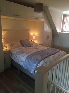a bed in a small room with a staircase at 1 bedroom apartment with parking. in Great Wakering