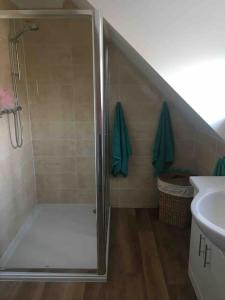 a shower with a glass door in a bathroom at 1 bedroom apartment with parking. in Great Wakering