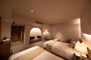 a hotel room with two beds and a window at THE GENERAL KYOTO Shijou Shinmachi in Kyoto