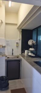 a kitchen with a sink and a counter top at Deluxe VIP Seaview Batu Ferringhi 1503 - 3 Rooms in Batu Ferringhi