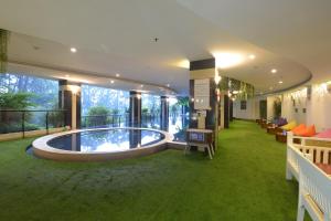a building with a pool in the middle of a room at Grand Savero Hotel Bogor in Bogor