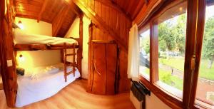 1 Schlafzimmer mit 2 Etagenbetten in einem Haus in der Unterkunft LADERAS DEL CAMPANARIO in San Carlos de Bariloche