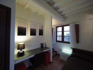 a room with a desk with a lamp and a window at Nice apartment in Gambassi Terme with shared pool in Gambassi Terme