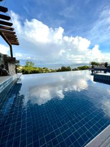 a swimming pool with a view of the sky at Villa Amihan in Puerto Galera