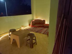 a room with a table and chairs and a couch at Private room in Dahab,10 minutes to sea in Dahab