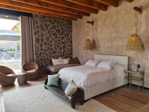 a bedroom with a bed and a couch in it at Impresionante Residencia de lujo en Condominio Top in San Miguel de Allende +44 photos