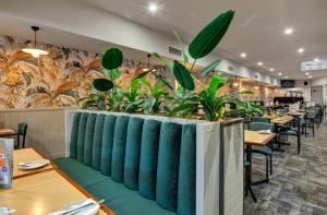 a restaurant with green plants on the wall at Gawler Arms Hotel in Gawler