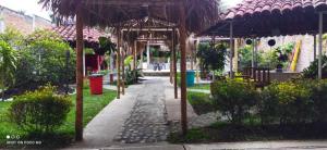 a garden with a pavilion with a trash can at El Buen Sazon Valluno 