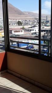 a window in a room with a view of a airport at Departamento 5 minutos Playa cavancha in Iquique