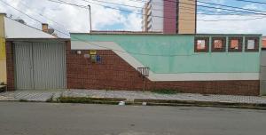 a building with a staircase on the side of a street at Suíte Próxima a Praias! in São Luís