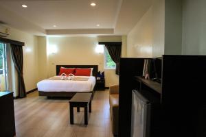 a bedroom with a bed with red pillows on it at Sky Villa Hua Hin Guesthouse - Adults-Only in Hua Hin