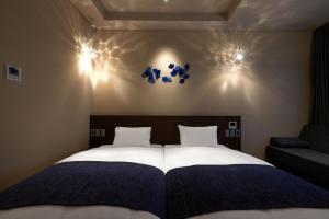 Ένα ή περισσότερα κρεβάτια σε δωμάτιο στο Minn Kanazawa