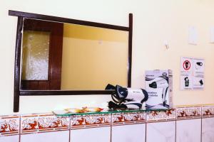 a mirror on a wall above a counter in a bathroom at T'ika Guest House in Cusco