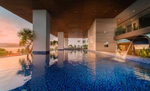 an infinity pool in a building with a swimming pool at Queen Ann Nha Trang Hotel in Nha Trang