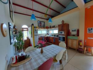 a kitchen with a table with flowers on it at Colours Land Home in Nha Trang