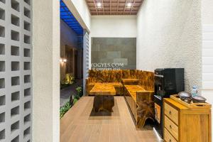 a lobby with wooden tables in a building at KESATRIYAN JOGJA GUEST HOUSE in Yogyakarta