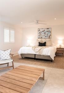 Un dormitorio con una cama, un sofá y una mesa. en Noosa Crest Penthouse 37 - Private Rooftop Pool, en Noosa Heads