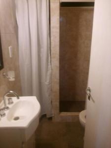 baño con lavabo y cortina de ducha en Casa Balneario Orense en 