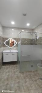 ein Bad mit einem Waschbecken und einem Spiegel in der Unterkunft Gabala Double villa in Qəbələ