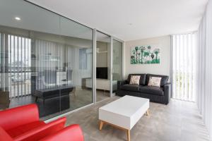 a living room with a couch and a table at Waverley apartment A-two bedrooms wifi available in Perth