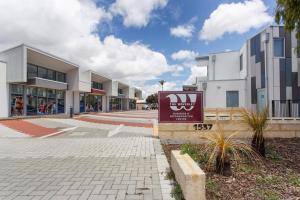a building with a sign in front of it at Waverley apartment A-two bedrooms wifi available in Perth