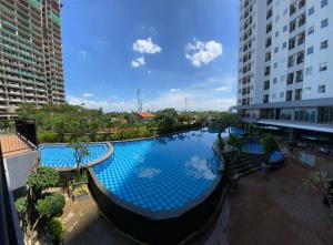 an overhead view of a large swimming pool in a city at Parkland Avenue Serpong BSD by Owner in Babakan