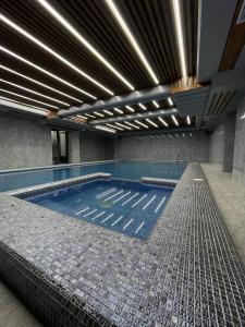 a large swimming pool in a building at Mir Luxe Plaza in Tashkent