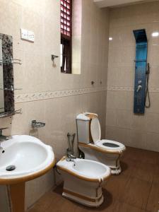 a bathroom with a toilet and a sink at Amani Lake Resort in Moratuwa