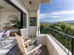 a balcony with chairs and a view of the mountains at Luxury Accomodation at the Alphen Glen in Cape Town